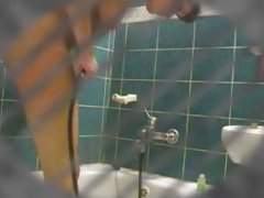 A secret camera watches this babe in the shower